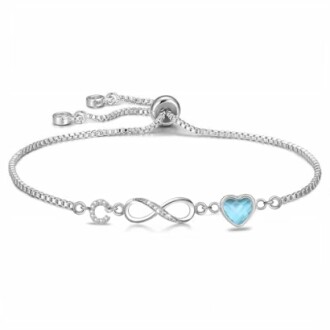Bracelet en argent avec symbole infini et cœur bleu.